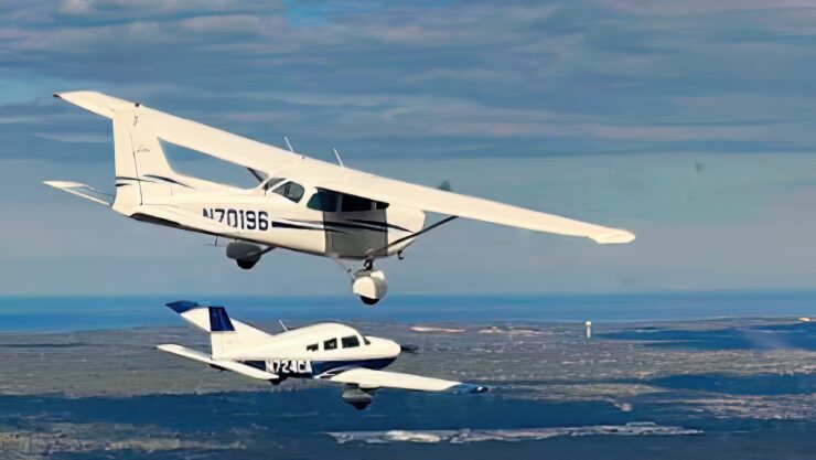 South Shore Flying Club’s low wing Piper Archer III and high wing Cessna 172 Skyhawk fly in formation. PHOTO/Karl Swenson