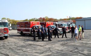 Shoreline Aviation President Keith Douglass, white shirt; Airport Assistant Manager Ben Garmin, yellow shirt; and Airport Manager Jason Tibbetts Marshfield Municipal Airport's setup to town firefighters.