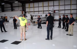 Marshfield Municipal Airport Assistant Manager Ben Garman describes differences in aircraft types. Airport Manager Jason Tibbets is at the right.