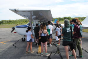 Marshfield Airport Commissioner Patrick MacAlister describes instrumentation to local Scouts.