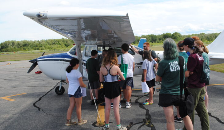 Marshfield Airport Commissioner Patrick MacAlister describes instrumentation to local Scouts.