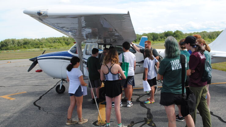 Marshfield Airport Commissioner Patrick MacAlister describes instrumentation to local Scouts.
