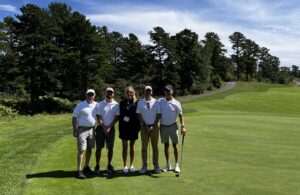 P.J. Flanagan, left, Steve Nery, Steve Swiech and Keith Douglass to help raise funds for the MBAA Aviation Scholarship Fund. Here, they surround Shoreline associate Erin Mulcahy.