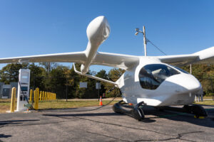 BETA Technologies’ ALIA 250 charges up at Shoreline Aviation’s Level 3 charging station at Marshfield Municipal Airport. Photo courtesy of BETA Technologies