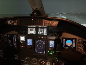 This is the interior of the LOFT simulator with a generated view of a runway at JFK Airport. 
