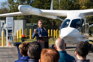 Shoreline Aviation President Keigh Douglass addresses the audience at Marshfield Municipal Airport. Photo courtesy of BETA Technologies