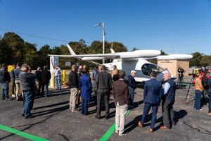 Shoreline Aviation's electric charging station event crowd gather around ALIA 250. 