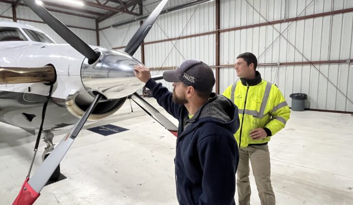 Line Service Manager Steve Dery, left, and Assistant Airport Manager Ben Garman inspect the Shoreline Aviation charter fleet’s Pilatus PC-12NG.