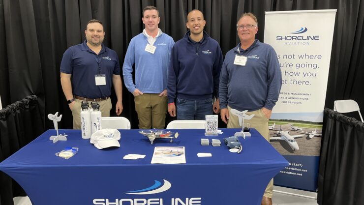 Sales and Operations Specialist Peter Bukuras, left, Charter Operations Manager Patrick Olson, Flight Logistician Logan Timpany, and Chief Pilot Wes Harris represent Shoreline Aviation at the 11th MBAA Aviation Day.