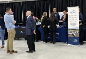 Patrick Olson discusses business with an Aviation Day attendee.