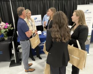 Keith Douglass and Erin Mulcahy shmooze with Aviation Day attendees.