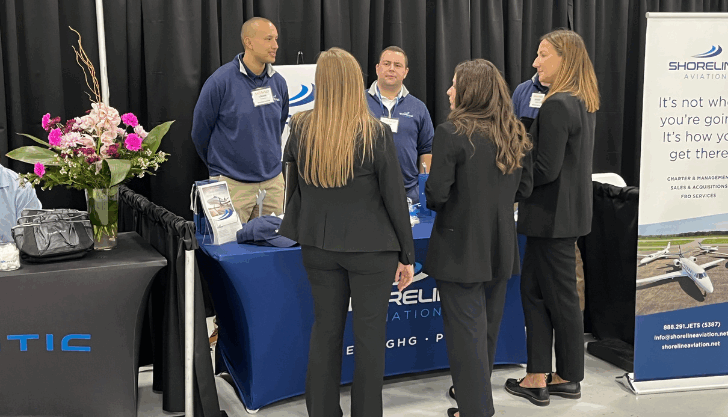 Logan Timpany, left, Evan Cadavieco and Manny Escobar chat with booth visitors at MBAA Aviation Day.