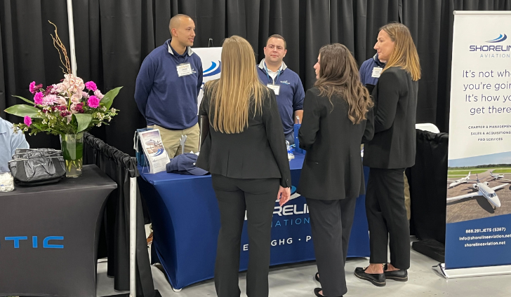 Logan Timpany, left, Evan Cadavieco and Manny Escobar chat with booth visitors at MBAA Aviation Day.