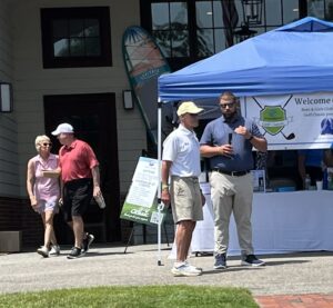 Boys & Girls Club CEO Jim Bunnell, center, describes the Golf Classic’s impact on the Boys & Girls Club.