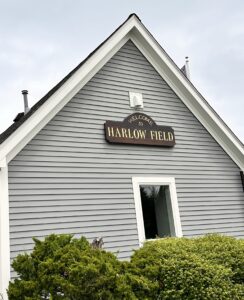A restored George D. Harlow Airfield sign greets visitors out front.