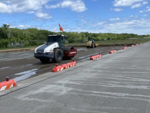 The base soil layer is prepped to take another layer before paving.