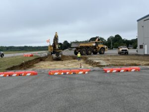 A 32-inch cut is being made into the ramp area next to Shoreline Aviation's jet hangar.