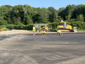 Workers measure for tiedown installations on the east ramp.