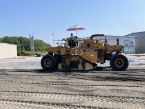 A Lawrence Lynch Corp. milling machine rips up main ramp asphalt and soil.