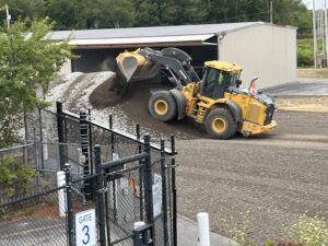 New soil is added to a mixture with repurposed asphalt and soil and new stone to create a new base layer. 