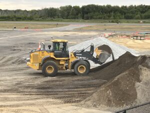 New soil is scooped up to go into a base layer mix.