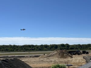 A plane takes off amid airport ramp construction.