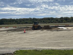 A bulldozer pushes P-209 material into place. 