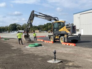 An island is being graded between the jet hangar ramp area and Taxiway Alpha. 