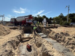 Electrical conduits are being encased in concrete. 