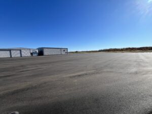 The main ramp at Marshfield Airport is an expanse of new black asphalt.