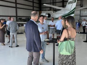Business community members network during the South Shore Chamber of Commerce Business After Hours event held with Shoreline Aviation at Marshfield Airport. 
