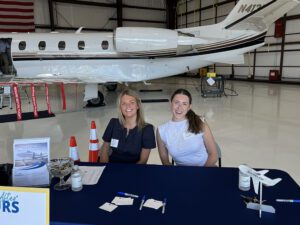 SSCC Membership, Event and Operations Coordinator Mackenzie Brewster, left, and Economic Development, Programs and Membership Coordinator Kate Tenney welcome Business After Hours in the jet hangar at Marshfield Municipal Airport. 