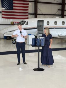 Shoreline Aviation General Manager Travis Barth names a recipient of a Shoreline Aviation gift bag, with Chamber Membership, Event and Operations Coordinator Mackenzie Brewster. Shoreline donated three gift bags to Business After Hours guests. 